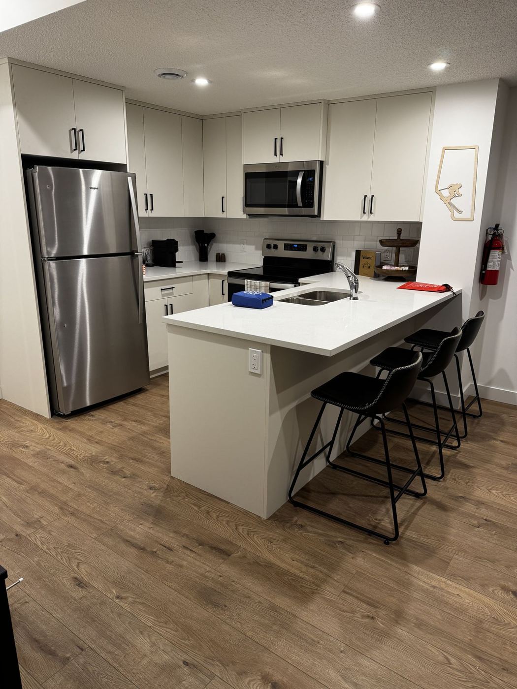 White kitchen with island and bar stools